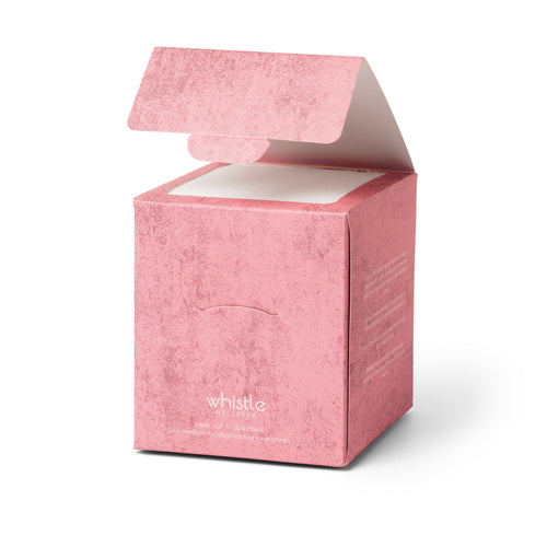 Open pink box of Whistle Wellness compact disposable face towels