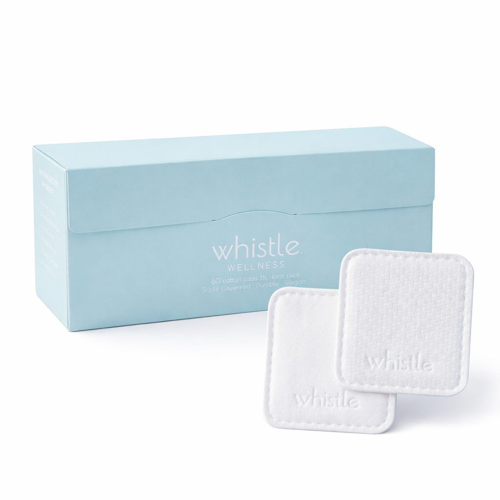 Whistle Wellness cotton face pads with smooth and textured sides beside a blue box